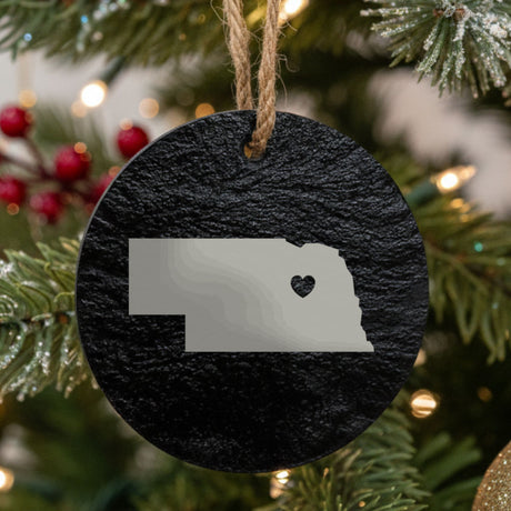 Nebraska round slate Christmas ornament engraved with the state shape and a heart
