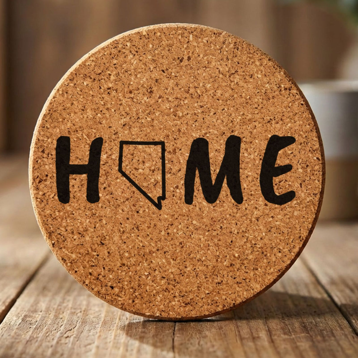 Nevada round cork coaster engraved with HOME using the state outline as the letter O