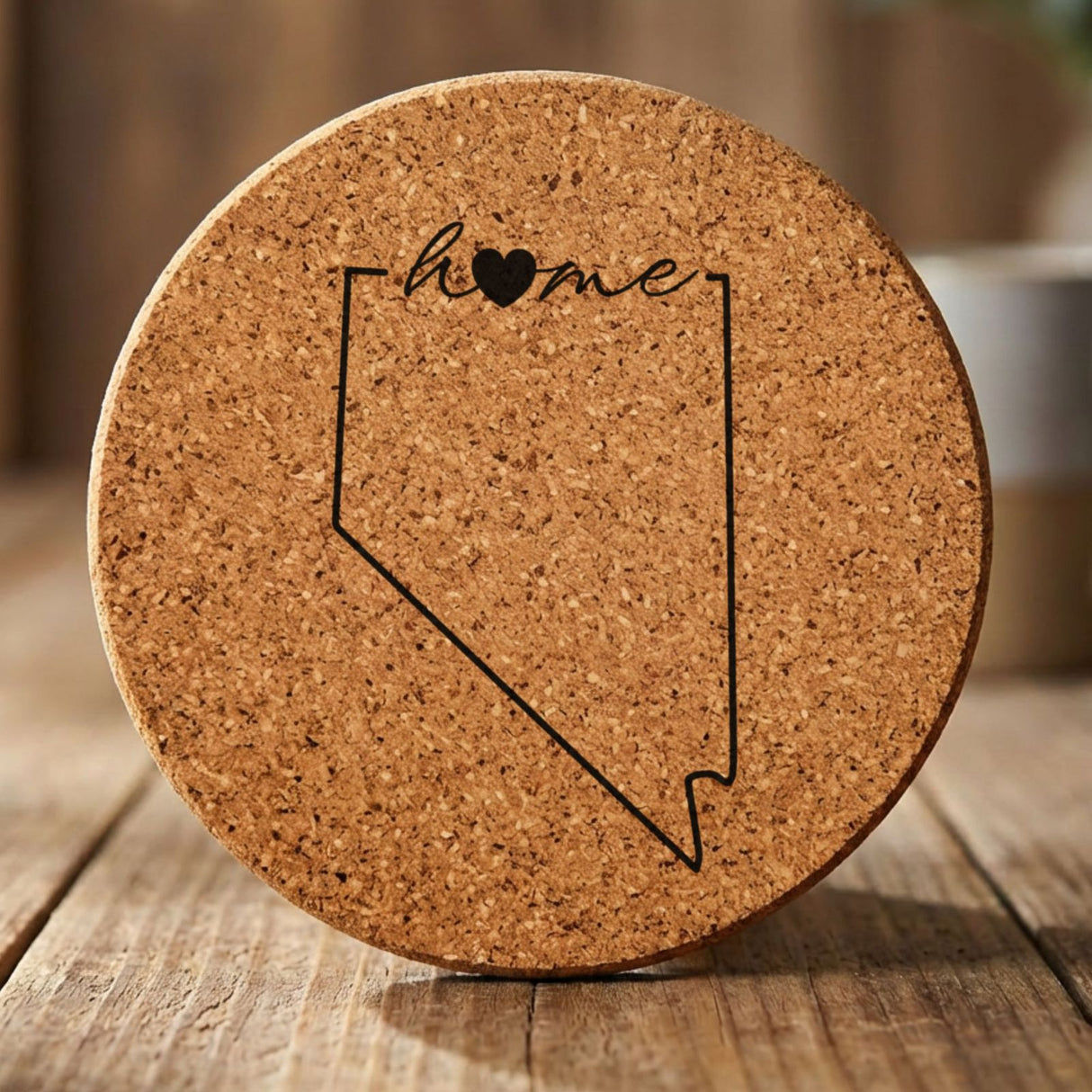 Nevada round cork coaster engraved with the state outline and home in script with a heart
