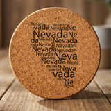 Nevada round cork coaster engraved with a word cloud of repeating Nevada text