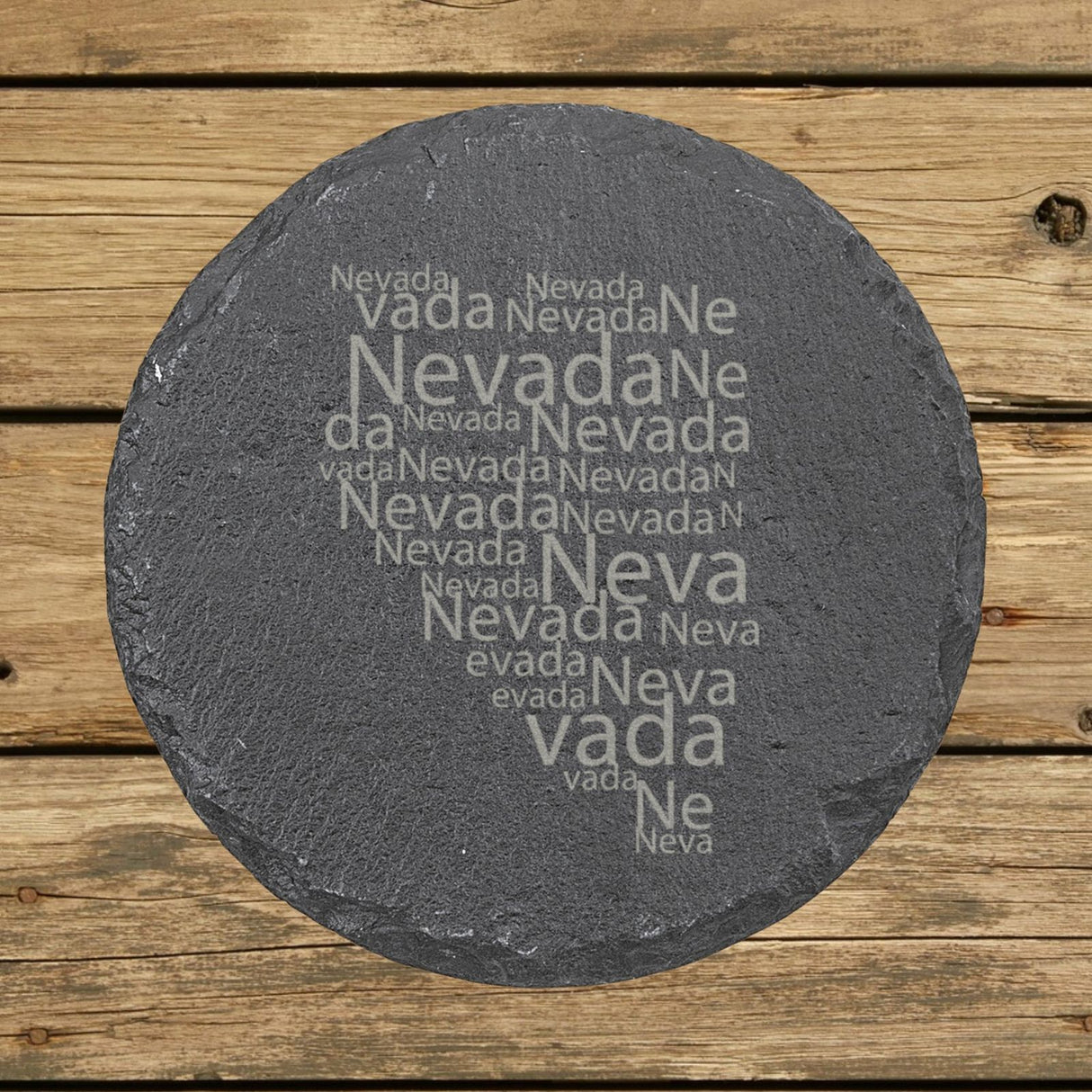 Nevada round slate coaster engraved with a word cloud of repeating Nevada text