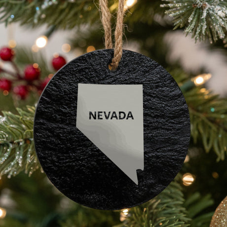 Nevada round slate Christmas ornament engraved with the state shape and NEVADA in bold lettering