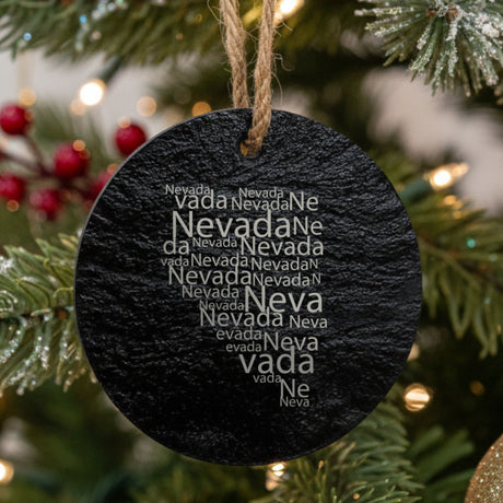 Nevada round slate Christmas ornament engraved with a word cloud of repeating Nevada text