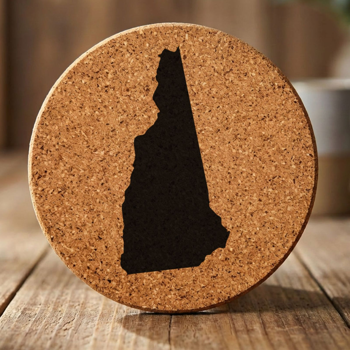 New Hampshire round cork coaster with the full state shape engraved
