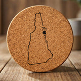 New Hampshire round cork coaster engraved with the state outline and home in script with a heart