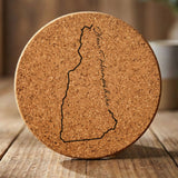 New Hampshire round cork coaster engraved with the state outline and New Hampshire in script lettering