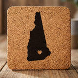 New Hampshire square cork coaster engraved with the state shape and a heart