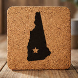 New Hampshire square cork coaster engraved with the state shape and a star