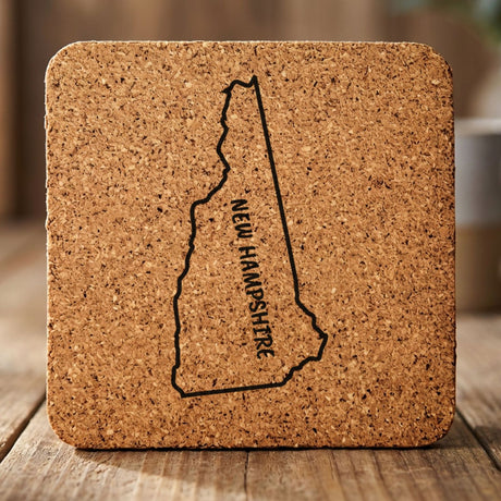 New Hampshire square cork coaster engraved with the state outline and NEW HAMPSHIRE running vertically