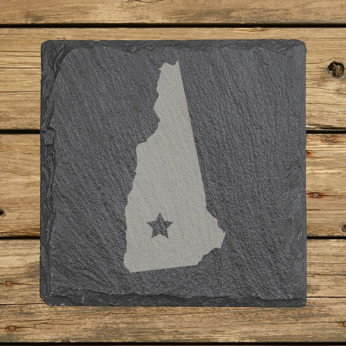 New Hampshire square slate coaster engraved with the state shape and a star