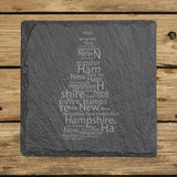 New Hampshire square slate coaster engraved with a word cloud of repeating New Hampshire text