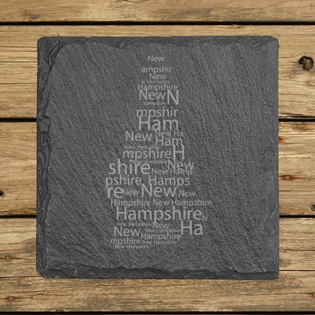 New Hampshire square slate coaster engraved with a word cloud of repeating New Hampshire text