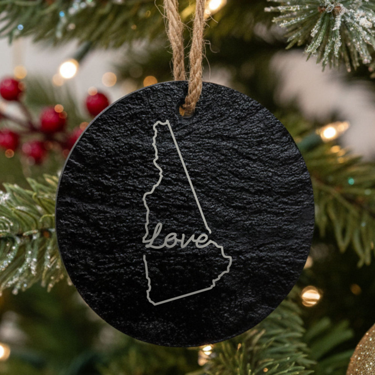 New Hampshire round slate Christmas ornament engraved with a hand-drawn state outline and love in cursive