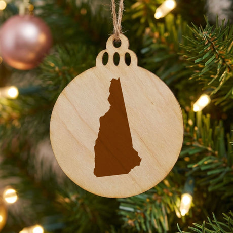 New Hampshire round wood Christmas ornament with the full state shape engraved