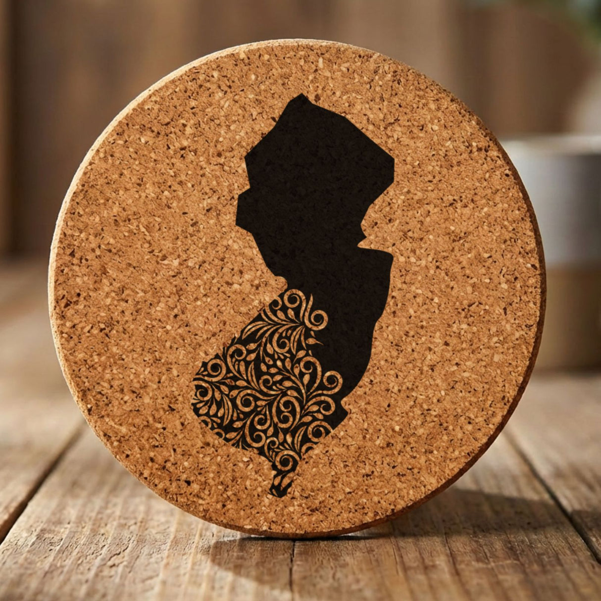 New Jersey round cork coaster engraved with the state shape in ornate floral scrollwork