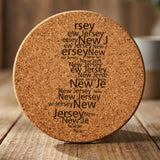 New Jersey round cork coaster engraved with a word cloud of repeating New Jersey text