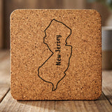 New Jersey square cork coaster engraved with the state outline and NEW JERSEY running vertically