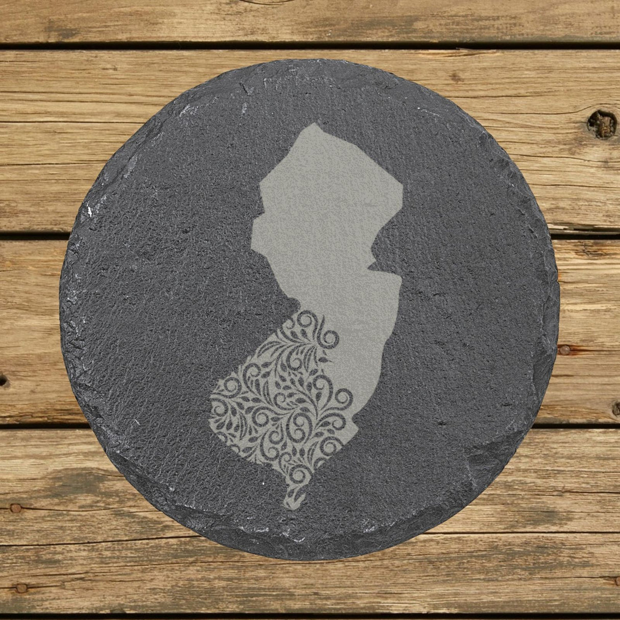 New Jersey round slate coaster engraved with the state shape in ornate floral scrollwork