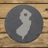 New Jersey round slate coaster engraved with the state shape and a heart