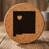 New Mexico round cork coaster engraved with the state shape and a heart