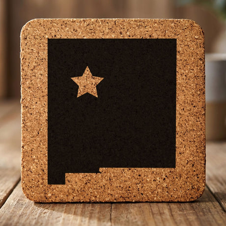 New Mexico square cork coaster engraved with the state shape and a star