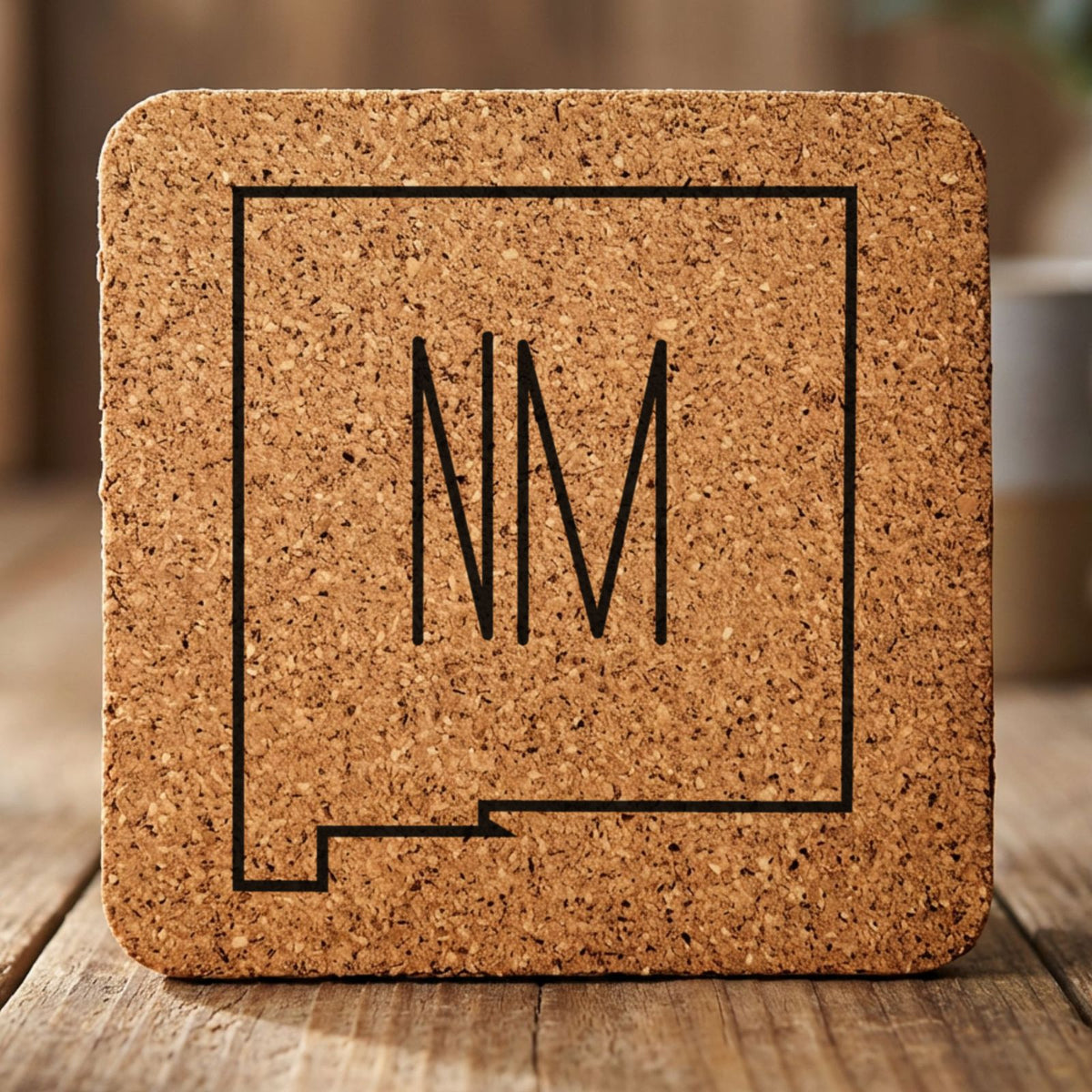 New Mexico square cork coaster engraved with the state outline and NM initials