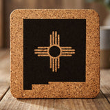 New Mexico square cork coaster engraved with the state shape and the Zia sun symbol