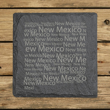 New Mexico square slate coaster engraved with a word cloud of repeating New Mexico text