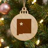 New Mexico round wood Christmas ornament engraved with the state shape and a star