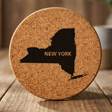 New York round cork coaster engraved with the state shape and NEW YORK in bold lettering