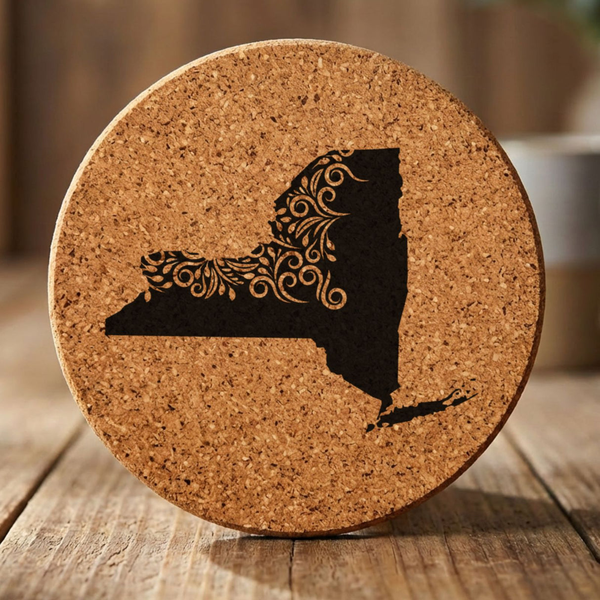 New York round cork coaster engraved with the state shape in ornate floral scrollwork