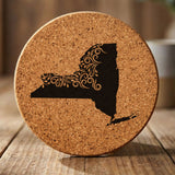 New York round cork coaster engraved with the state shape in ornate floral scrollwork