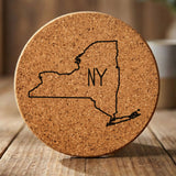 New York round cork coaster engraved with the state outline and NY initials