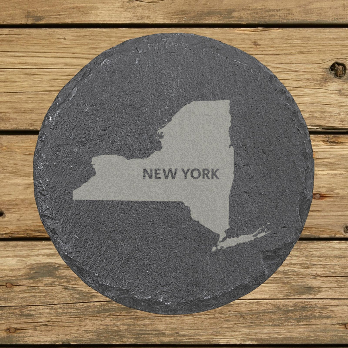 New York round slate coaster engraved with the state shape and NEW YORK in bold lettering