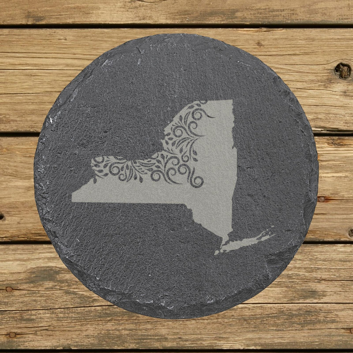 New York round slate coaster engraved with the state shape in ornate floral scrollwork