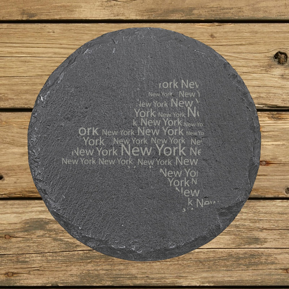 New York round slate coaster engraved with a word cloud of repeating New York text