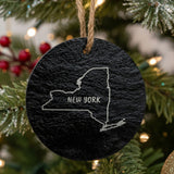 New York round slate Christmas ornament engraved with the state outline and NEW YORK in hand-drawn brush lettering