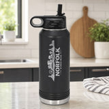 Black 32 oz insulated water bottle laser engraved with the Norfolk, Virginia skyline running up the side, standing on a kitchen counter