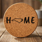North Carolina round cork coaster engraved with HOME using the state outline as the letter O