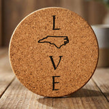 North Carolina round cork coaster engraved with LOVE stacked vertically using the state as the letter O