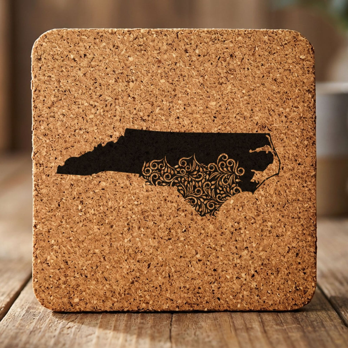 North Carolina square cork coaster engraved with the state shape in ornate floral scrollwork