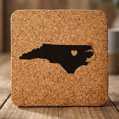 North Carolina square cork coaster engraved with the state shape and a heart