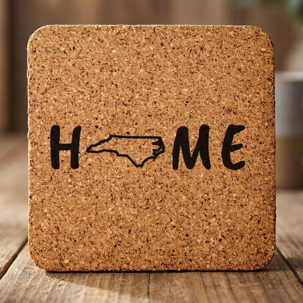 North Carolina square cork coaster engraved with HOME using the state outline as the letter O