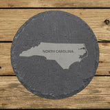 North Carolina round slate coaster engraved with the state shape and NORTH CAROLINA in bold lettering