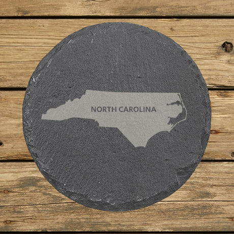 North Carolina round slate coaster engraved with the state shape and NORTH CAROLINA in bold lettering