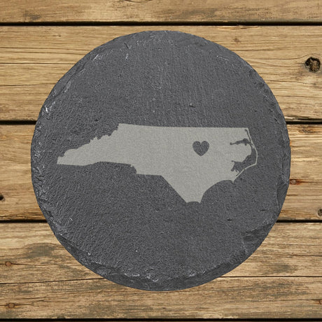 North Carolina round slate coaster engraved with the state shape and a heart