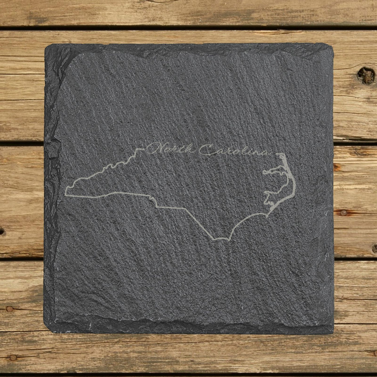 North Carolina square slate coaster engraved with the state outline and North Carolina in script lettering