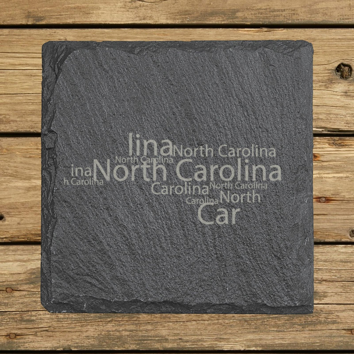 North Carolina square slate coaster engraved with a word cloud of repeating North Carolina text
