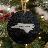 North Carolina round slate Christmas ornament engraved with the state shape and NORTH CAROLINA in bold lettering