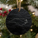 North Carolina round slate Christmas ornament engraved with the state outline and North Carolina in script lettering